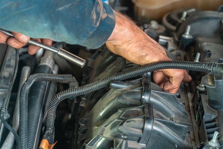 Mechanic working on a car engine bay